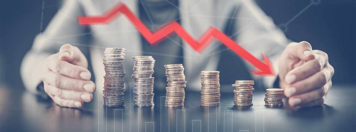 Mujer sentada con varios montones de monedas y una flecha decreciente